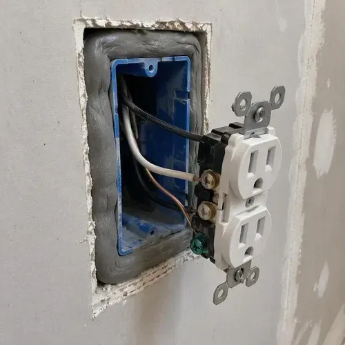 Electrical box sealed with acoustic putty pad on a drywall soundproofing job in Kingston, ON