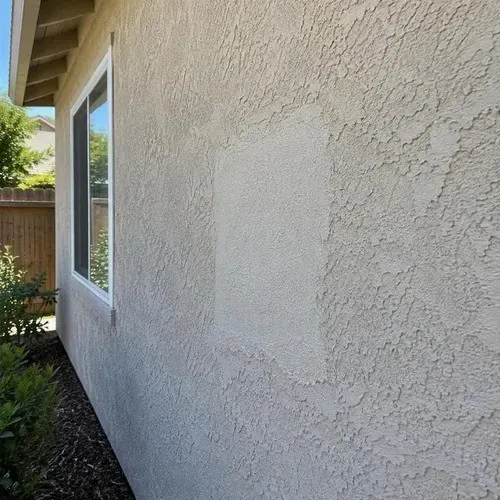 Repaired stucco wall with matched surface texture on a stucco repair job in the Kingston area